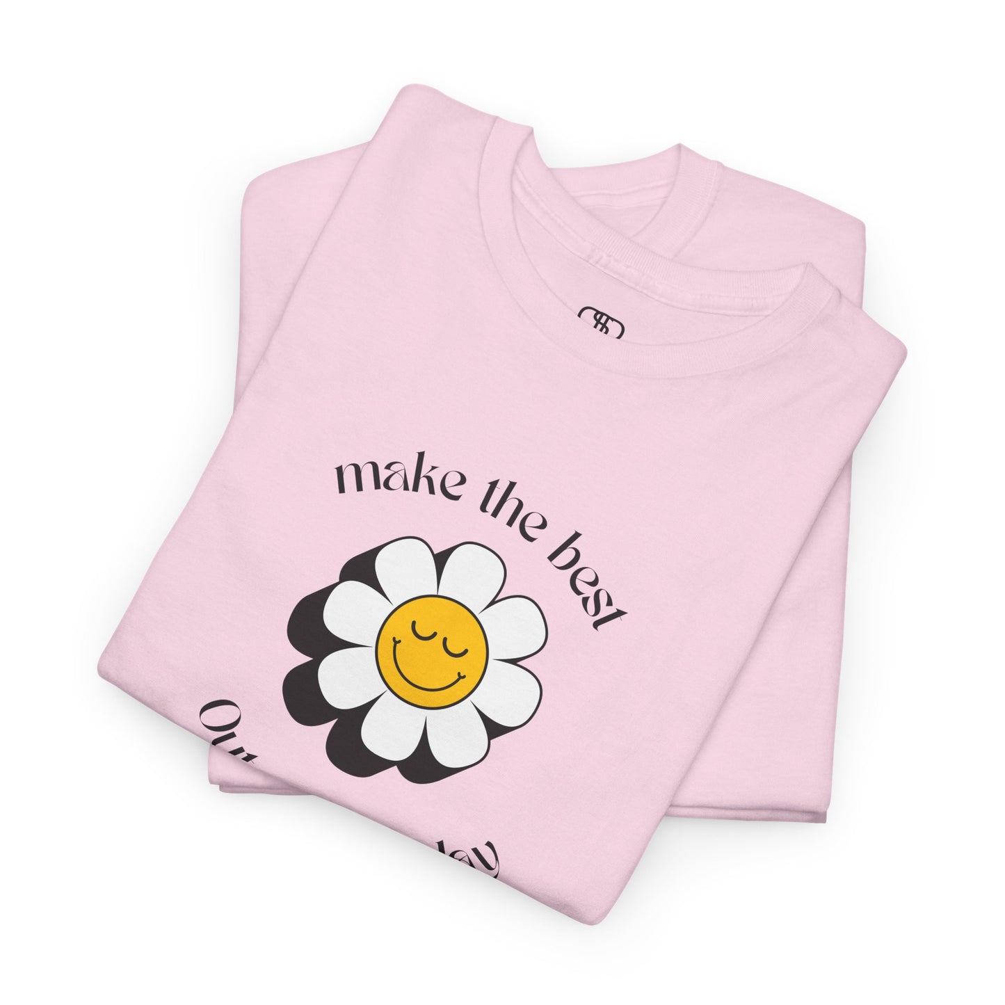 A folded light pink t-shirt with a smiling sunflower and the words “Make the best out of Everyday” on the front and “Dear Person behind me, I’m glad that you are here” on the back.
