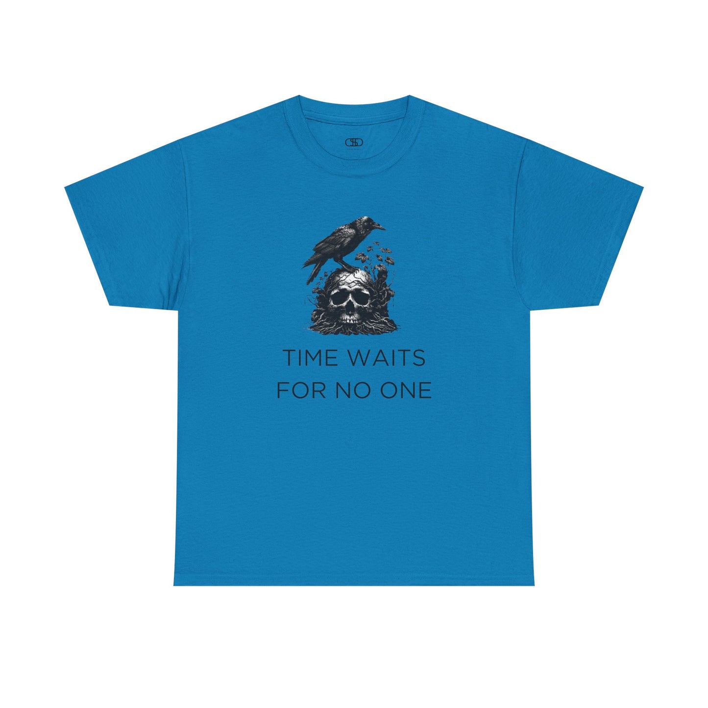 A close-up of a t-shirt with a gothic illustration. A black crow stands atop a weathered skull, which has moss and delicate vines growing through its eye sockets and around its form, blending nature and death.