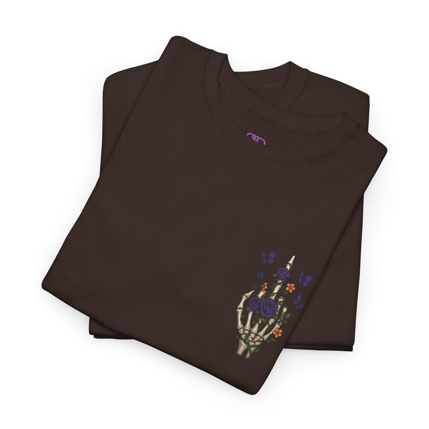 A folded dark brown t-shirt with a skeleton hand flipping its middle finger on the front surrounded by vines, roses, & butterflies, and a full skeleton design on the back with the phrase “My Last Flying Fuck.”