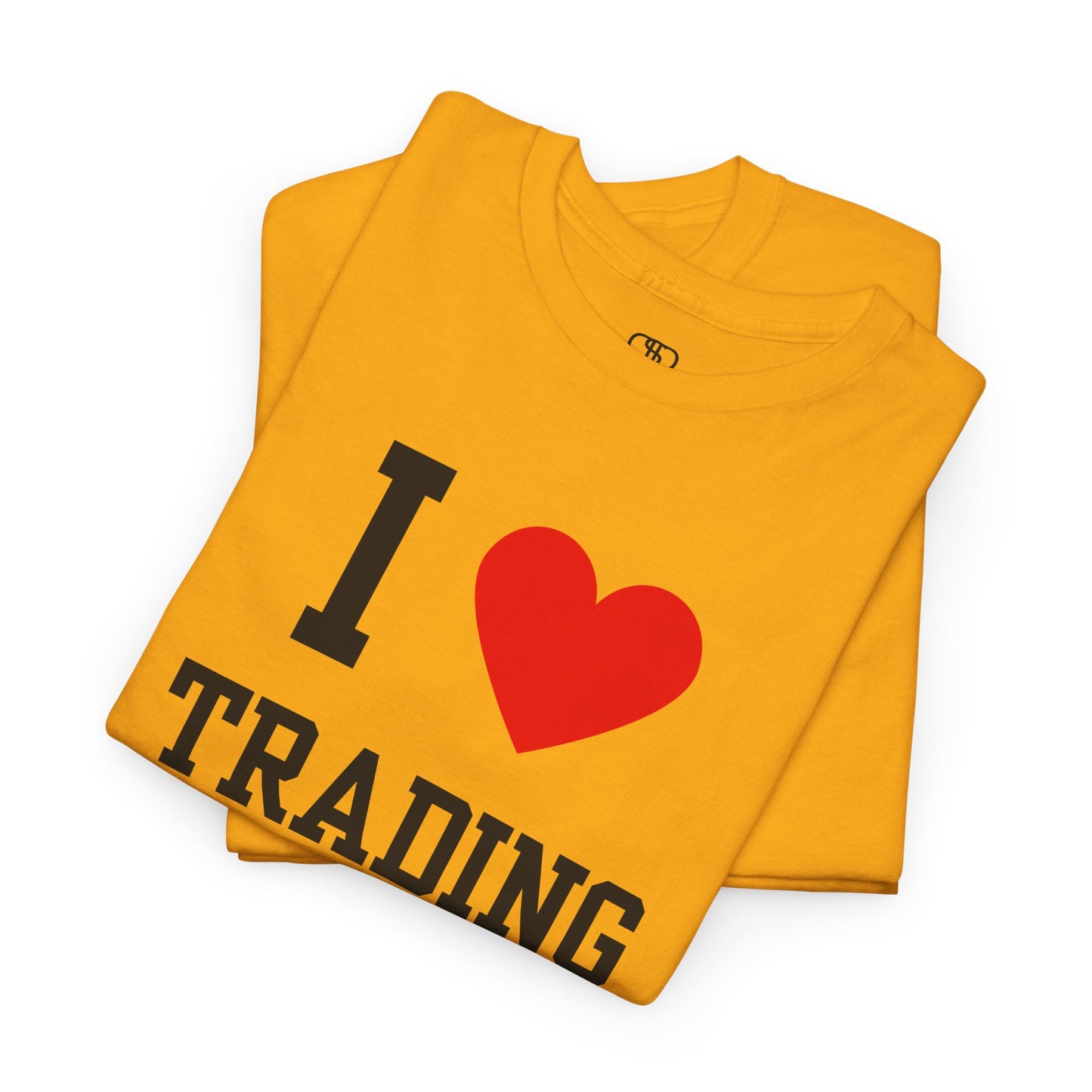 A minimalist folded gold t-shirt featuring the "I Love design with the text "I," a red heart symbol, and the word "Trading" underneath.