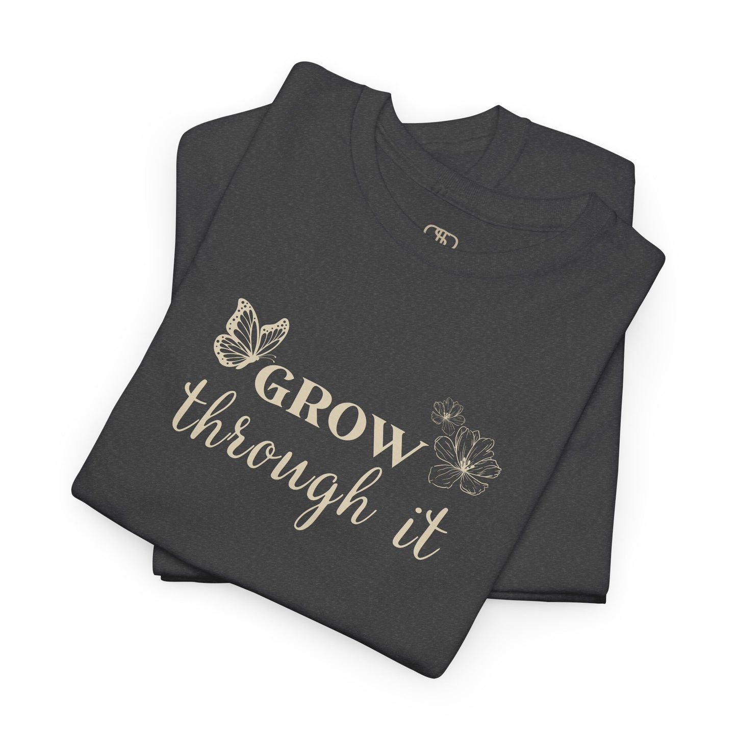 A folded dark heather t-shirt with "Grow Through It" and a butterfly on the front and a design of a spine with vines, flowers, and butterflies on the back.