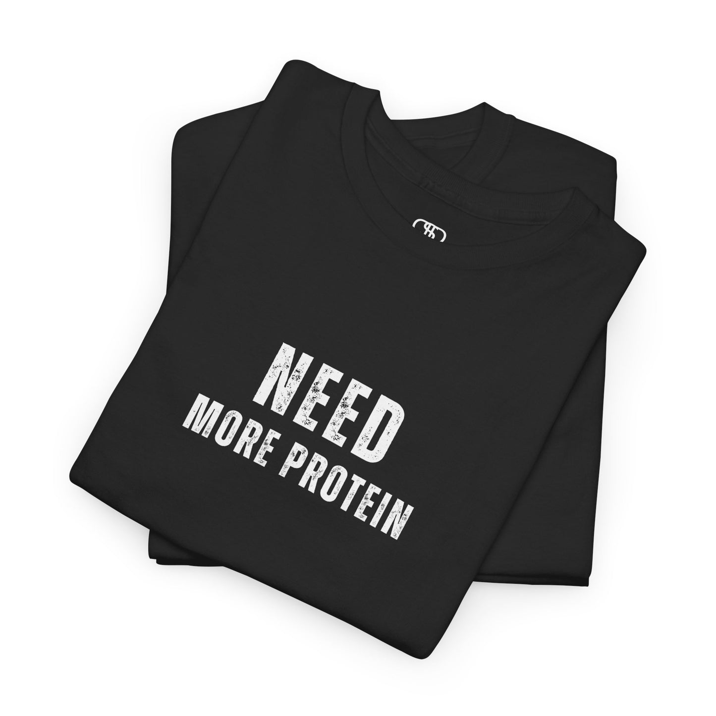 A folded black t-shirt with the words “Need Protein” in a large grunge font.