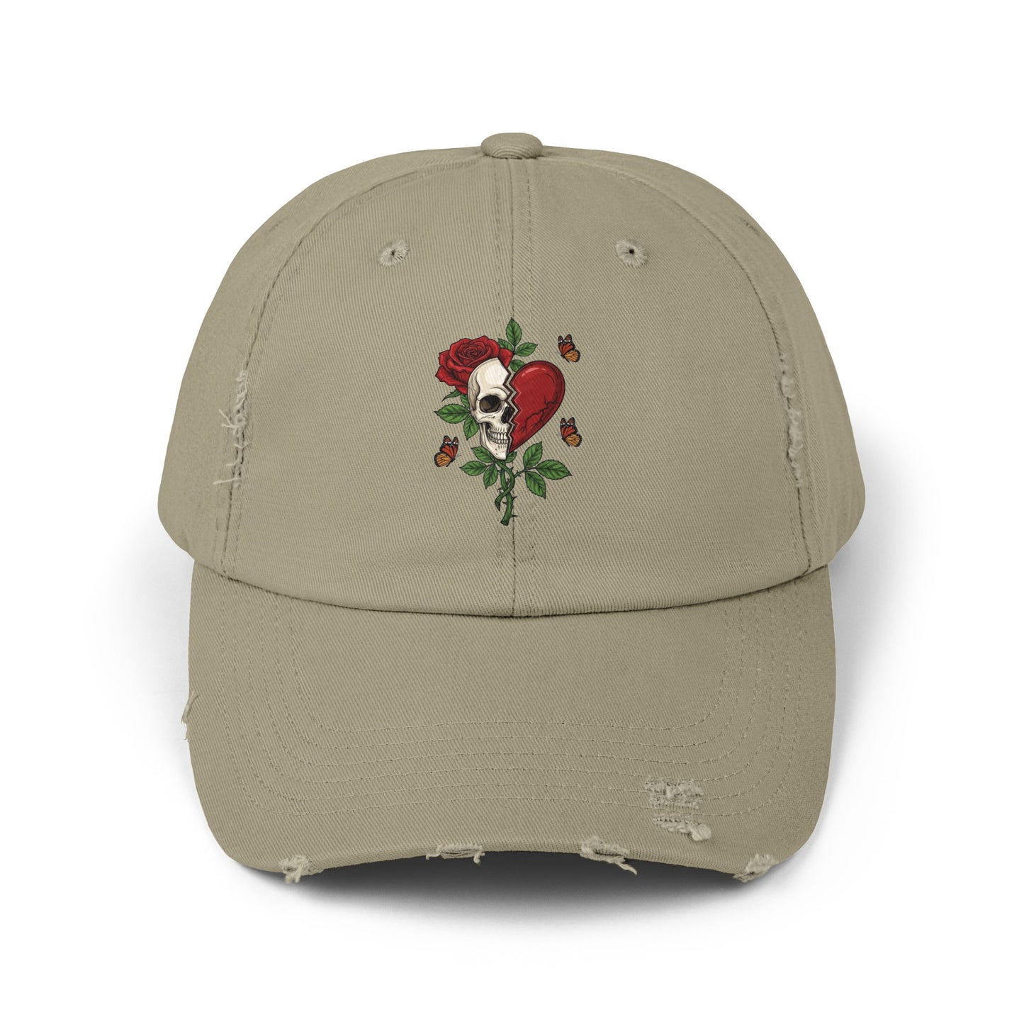 A distressed hat with an embroidered design of a half-skull and half-heart, split by a tear. A rose grows from the skull, surrounded by thorns and butterflies.