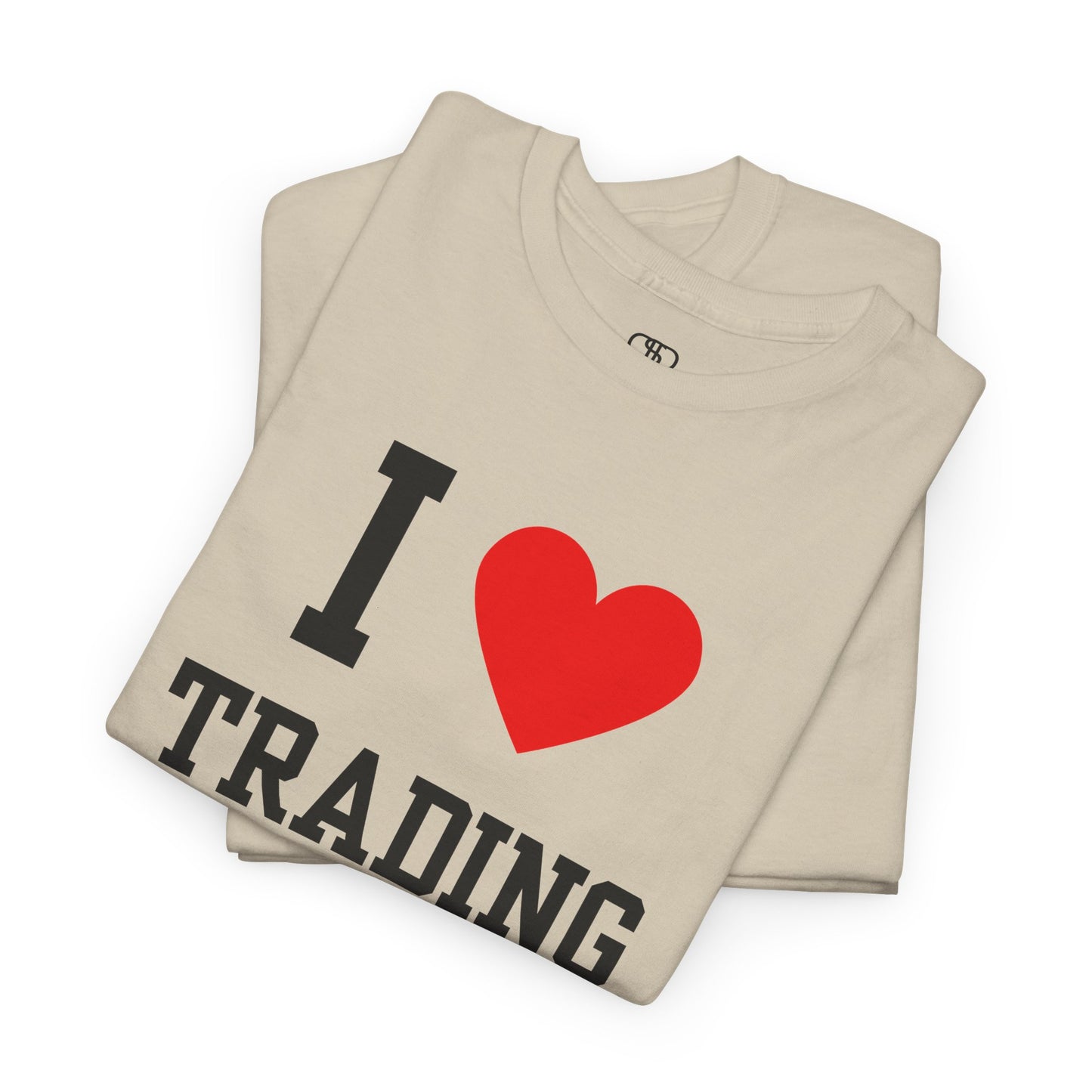 A minimalist sand folded t-shirt featuring the "I Love design with the text "I," a red heart symbol, and the word "Trading" underneath.