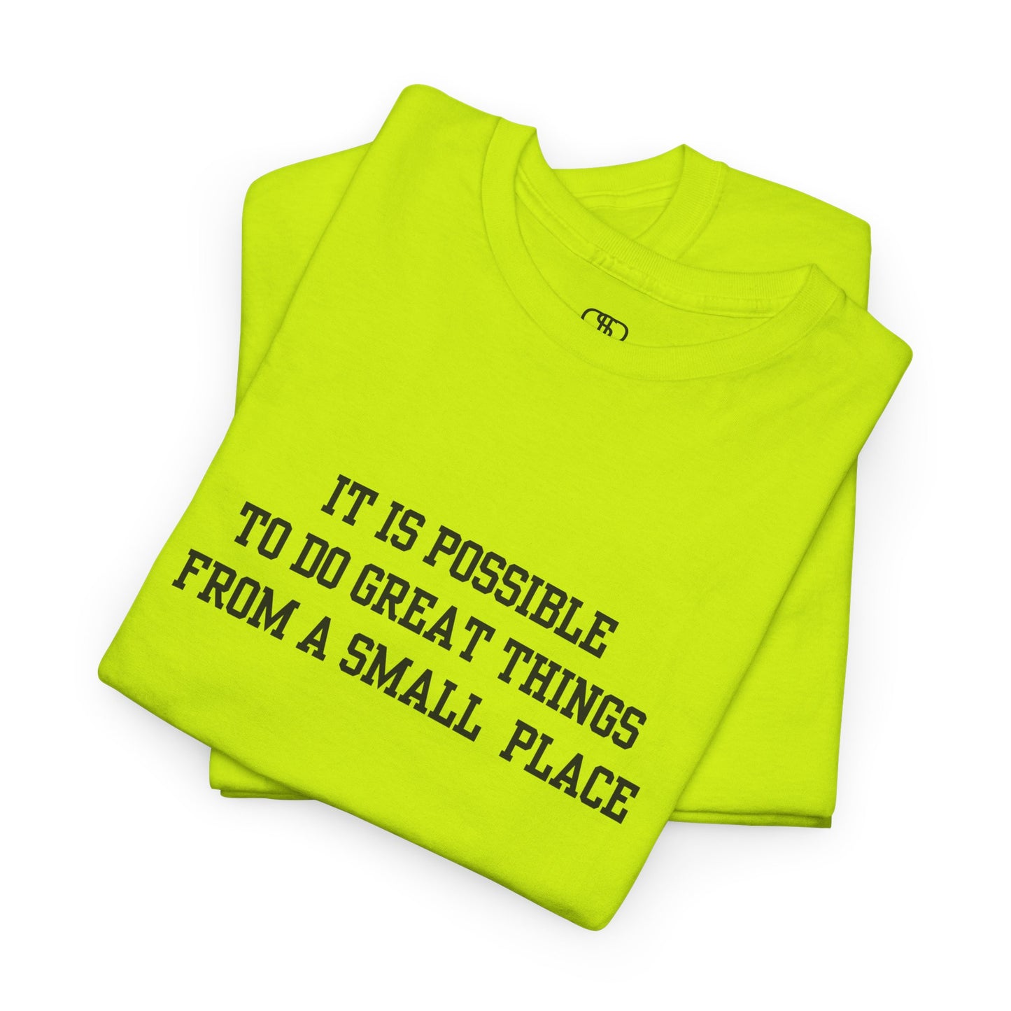 A folded safety green t-shirt with the quote “It is possible to do great things from a small place” on the front.