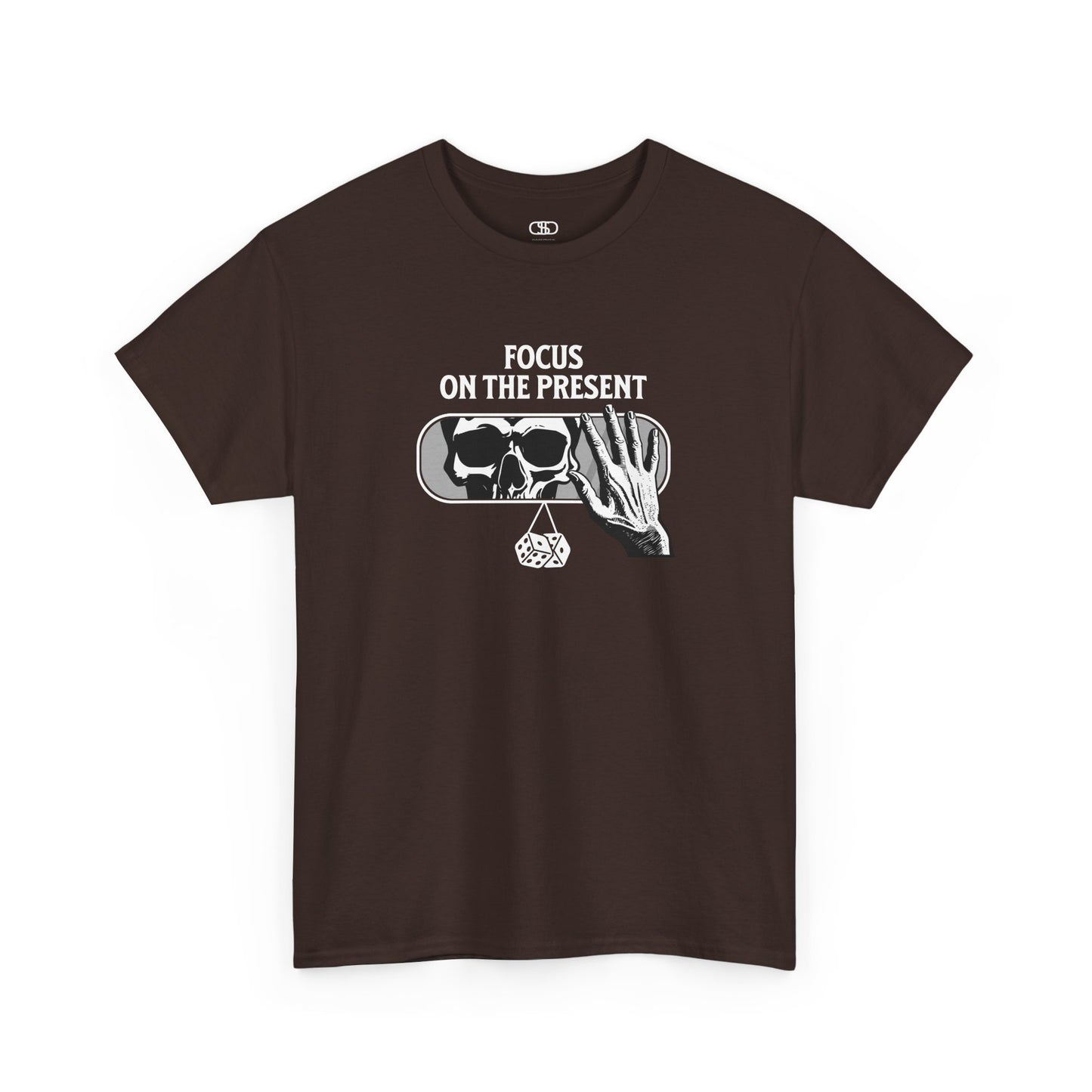 A t-shirt graphic of a car's rearview mirror reflecting a skeleton's face. A living hand reaches toward the mirror, which has dice dangling from it. The phrase “Focus on the present” is part of the design.