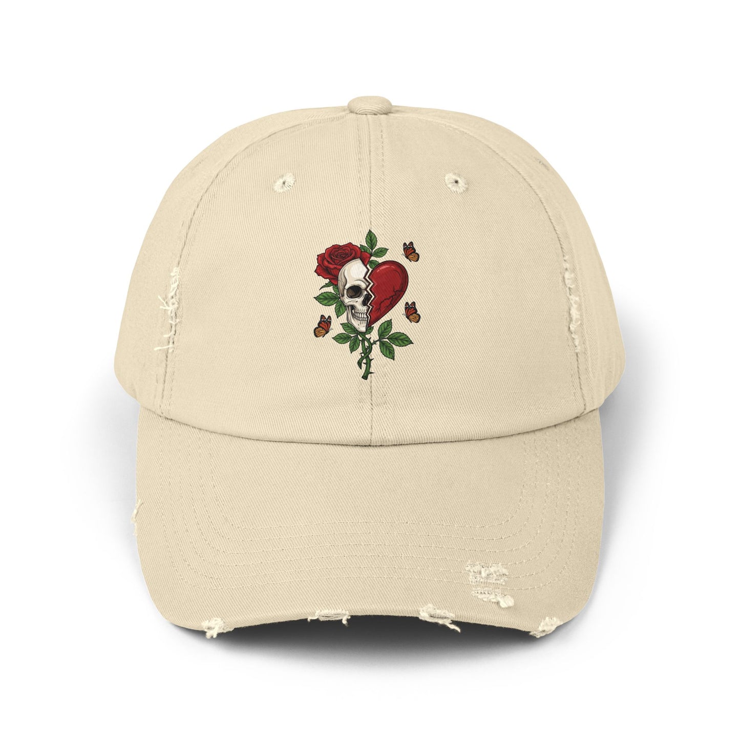 A distressed hat with an embroidered design of a half-skull and half-heart, split by a tear. A rose grows from the skull, surrounded by thorns and butterflies.