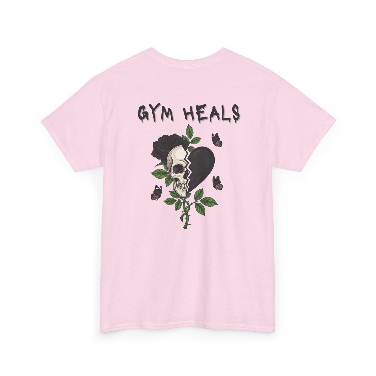 A light pink t-shirt with a front design of a half skull, half broken heart, and a rose. The back reads "Gym Heals" in black.