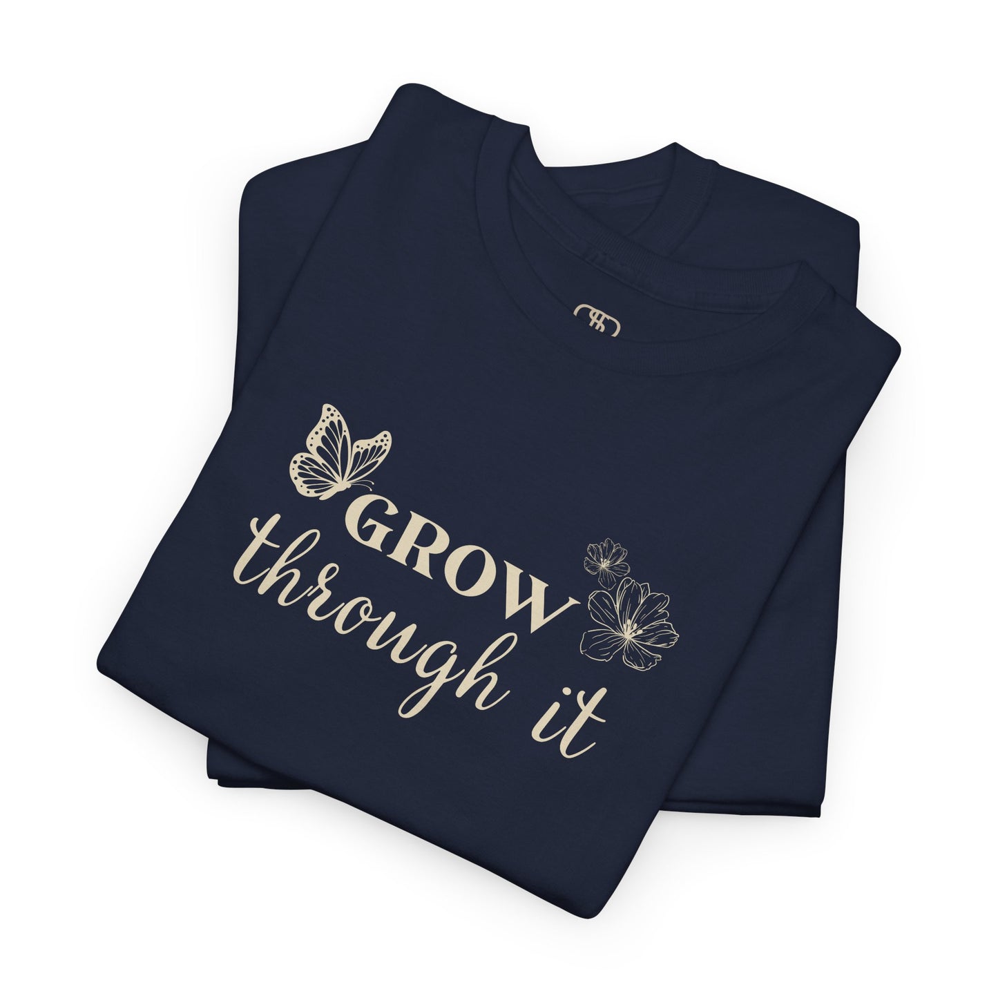 A folded navy t-shirt with "Grow Through It" and a butterfly on the front and a design of a spine with vines, flowers, and butterflies on the back.