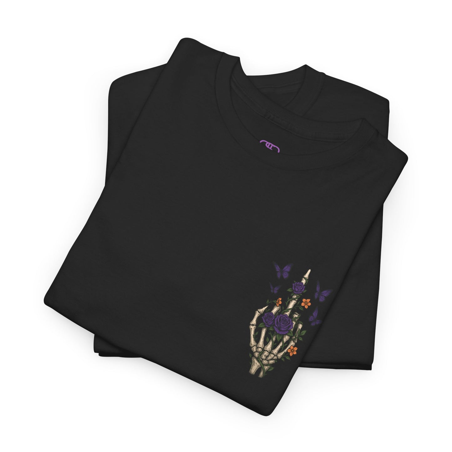 A folded black t-shirt with a skeleton hand flipping its middle finger on the front surrounded by vines, roses, & butterflies, and a full skeleton design on the back with the phrase “My Last Flying Fuck.”