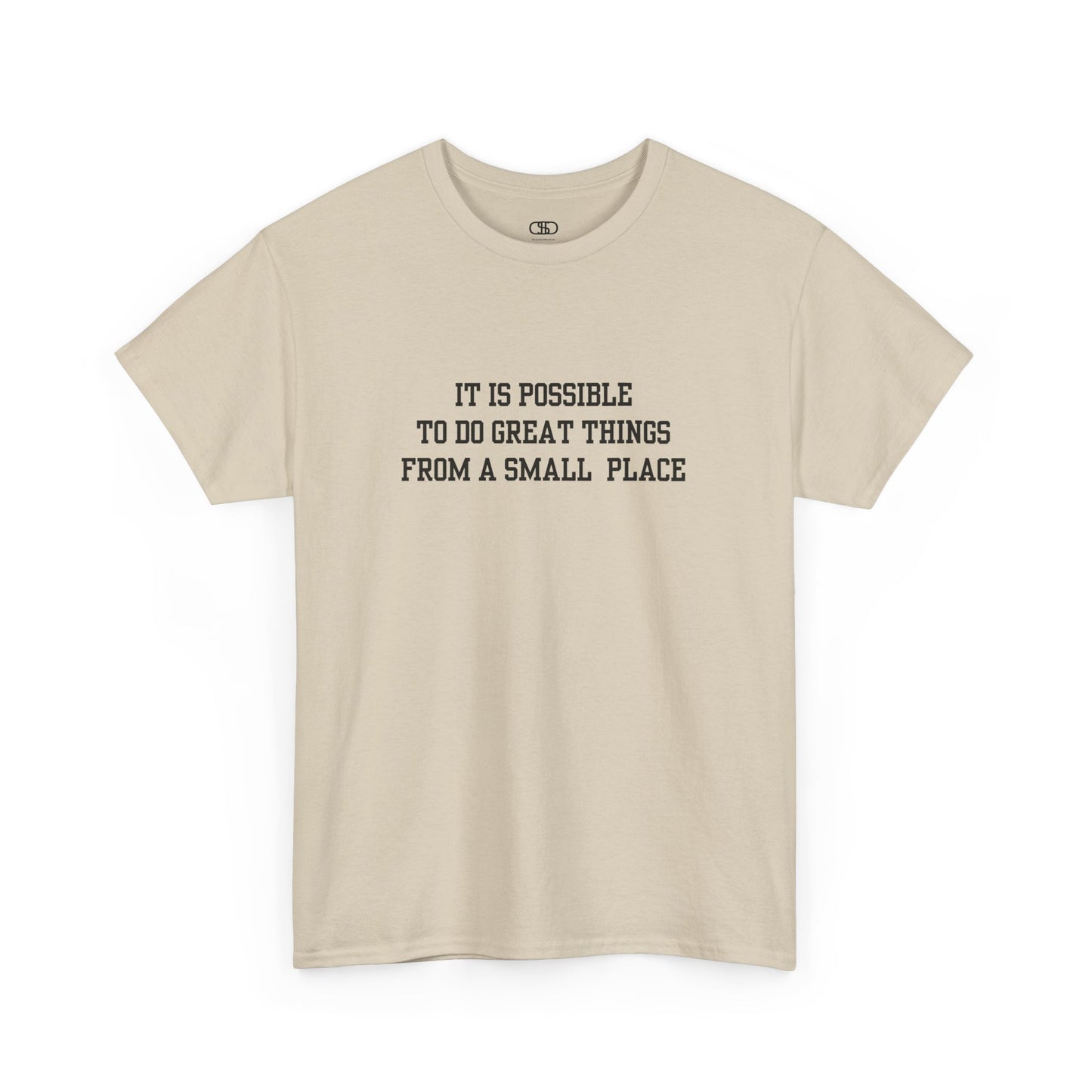 A sand t-shirt with the quote “It is possible to do great things from a small place” on the front.
