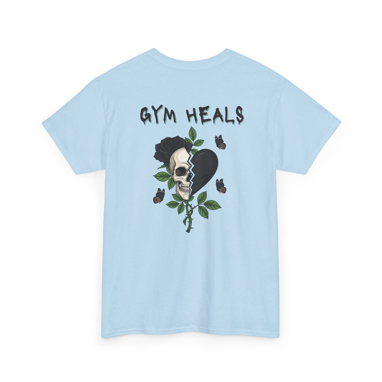 A light blue t-shirt with a front design of a half skull, half broken heart, and a rose. The back reads "Gym Heals" in black.