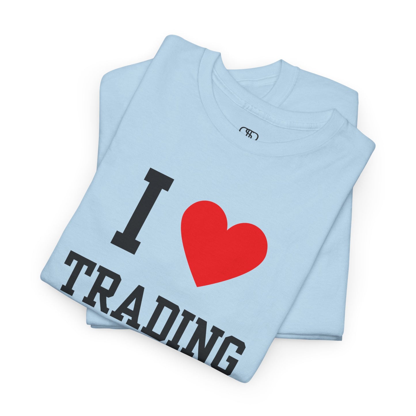 A minimalist folded light blue t-shirt featuring the "I Love design with the text "I," a red heart symbol, and the word "Trading" underneath.