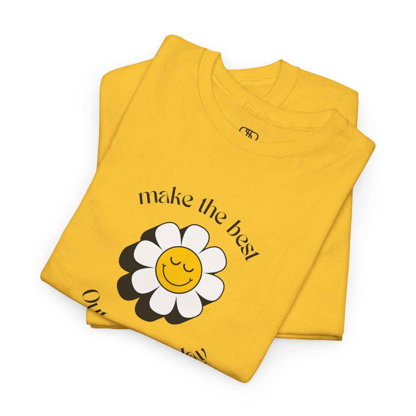 A folded daisy t-shirt with a smiling sunflower and the words “Make the best out of Everyday” on the front and “Dear Person behind me, I’m glad that you are here” on the back.