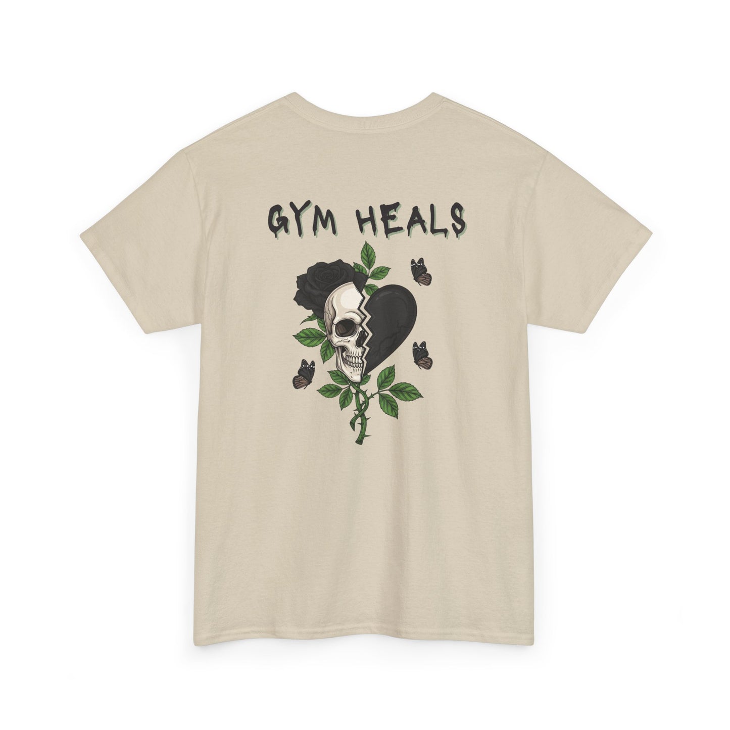 A t-shirt with a front design of a half skull, half broken heart, and a rose. The back reads "Gym Heals" in black.