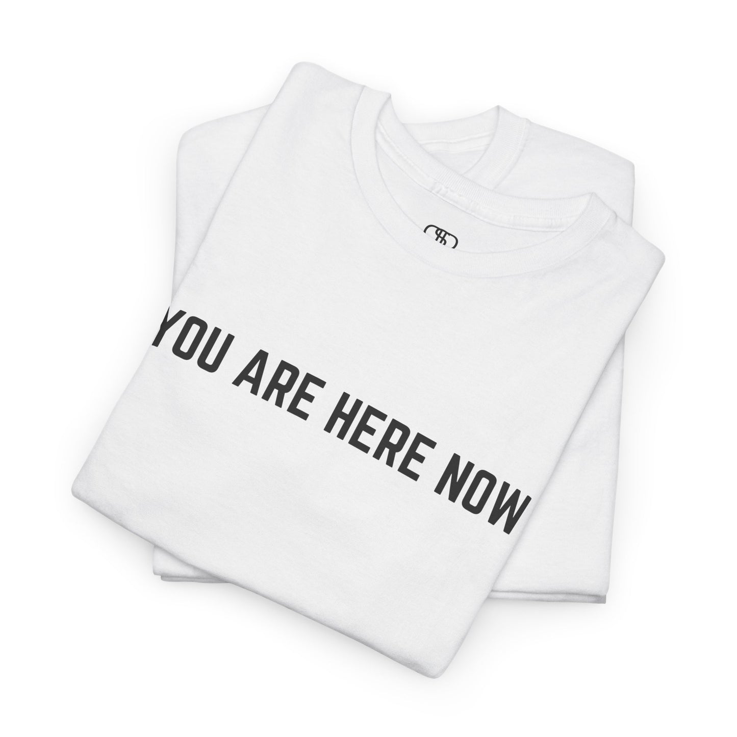 Front of a t-shirt with the grounding phrase "You are Here now" in a clean, minimalist font.