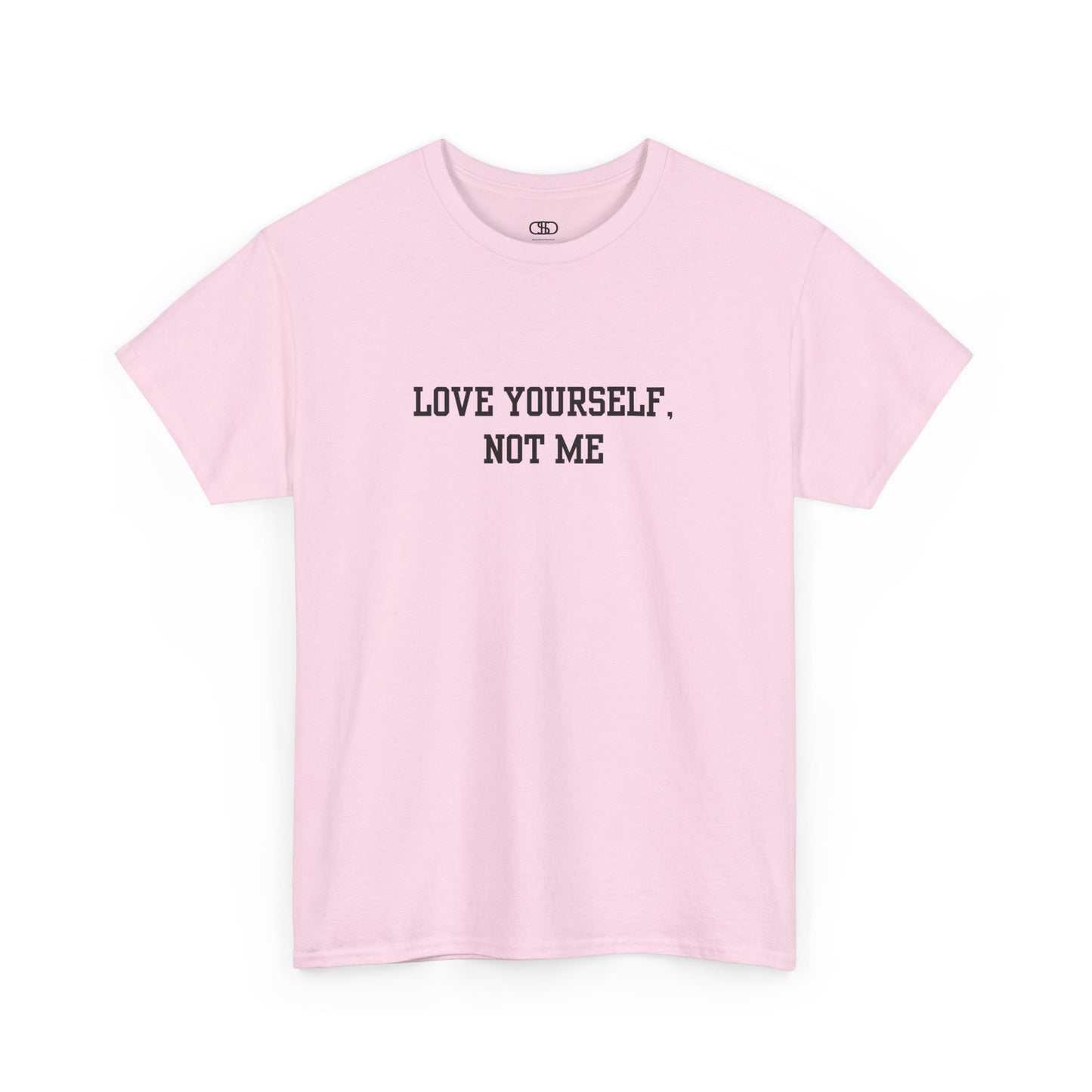 A minimalist light pink t-shirt with the bold, centered text "Love yourself, not me" in a clean, modern font.