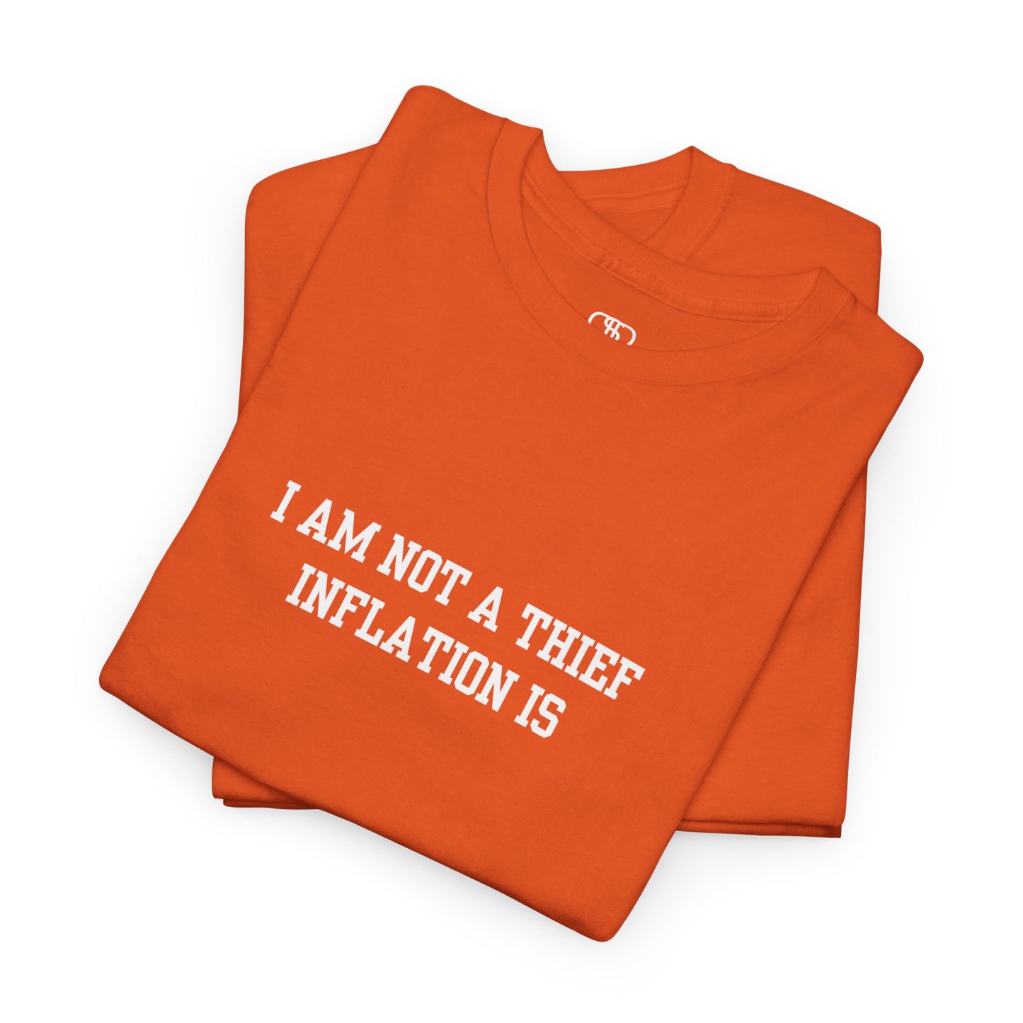A folded orange t-shirt with the phrase “I am not a thief Inflation is” on the front.