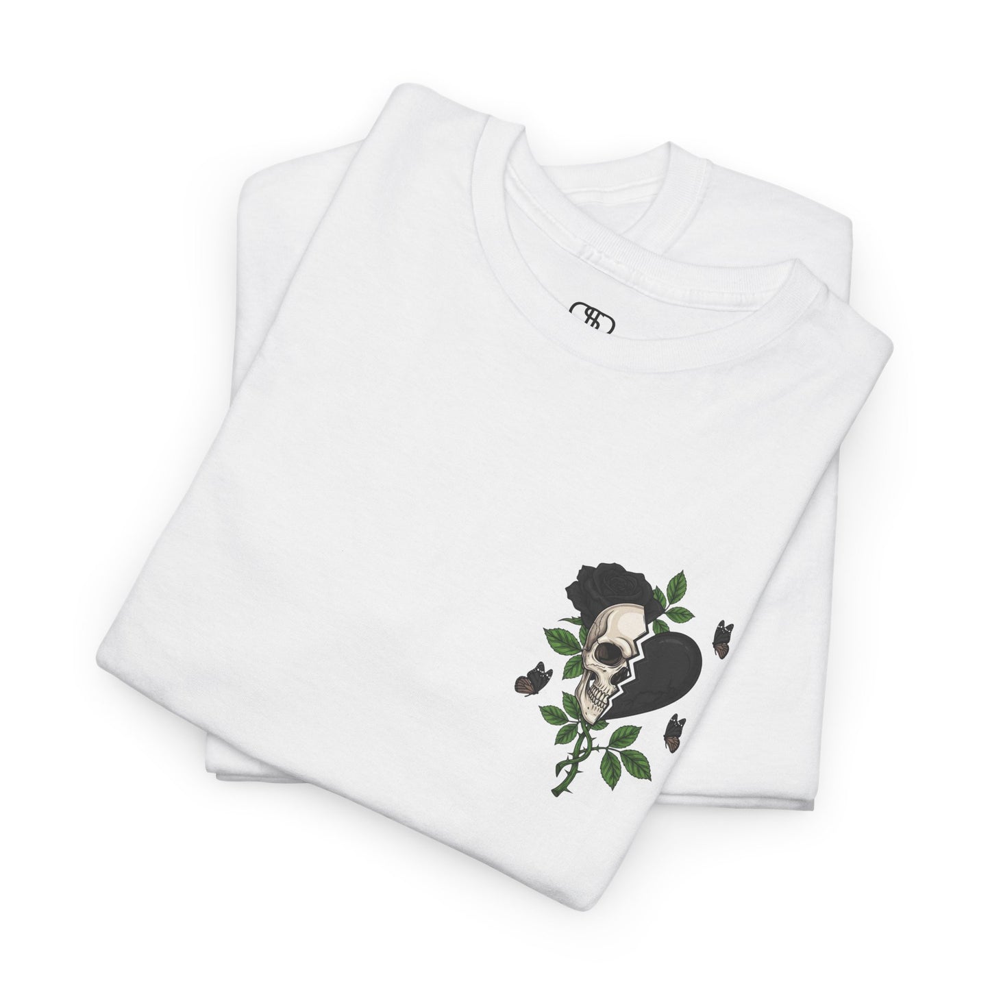 A folded white t-shirt with a front design of a half skull, half broken heart, and a rose. The back reads "Gym Heals" in black.