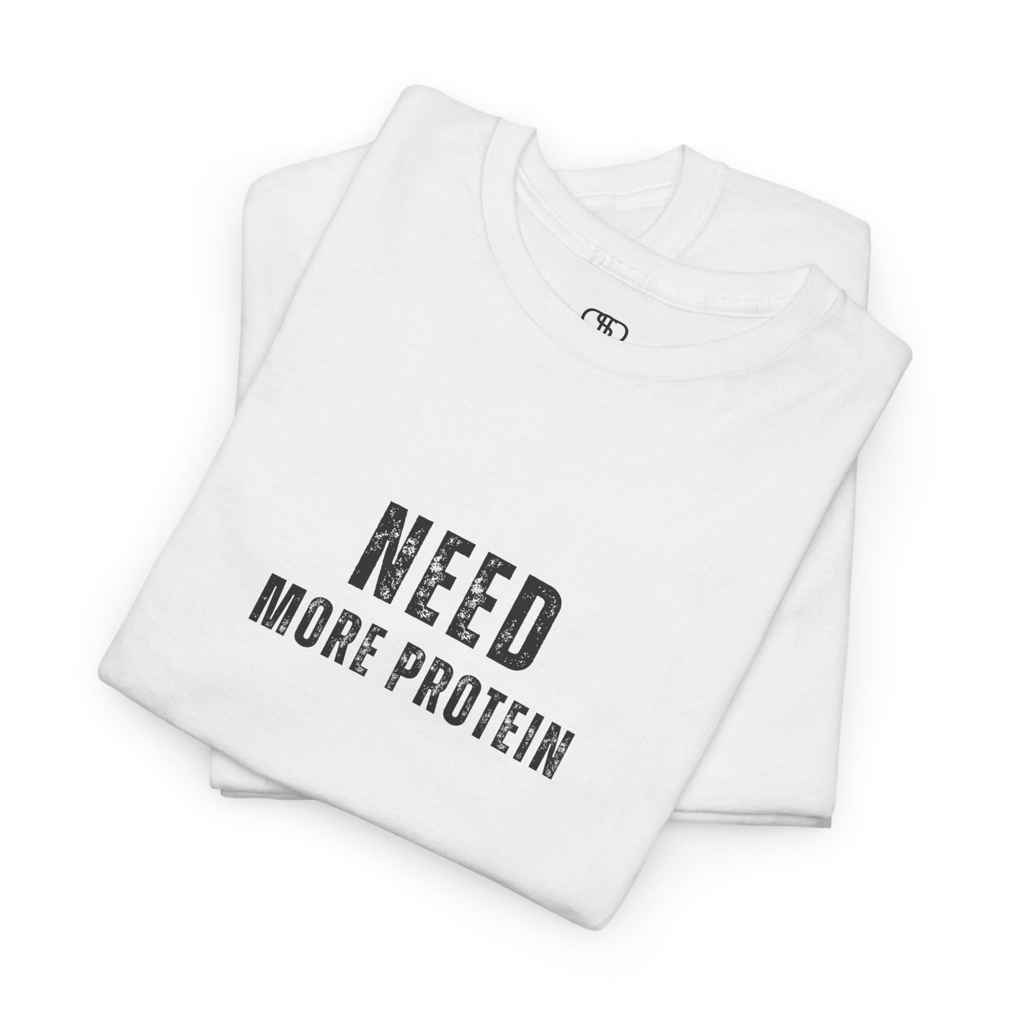 A folded white t-shirt with the words “Need Protein” in a large grunge font.