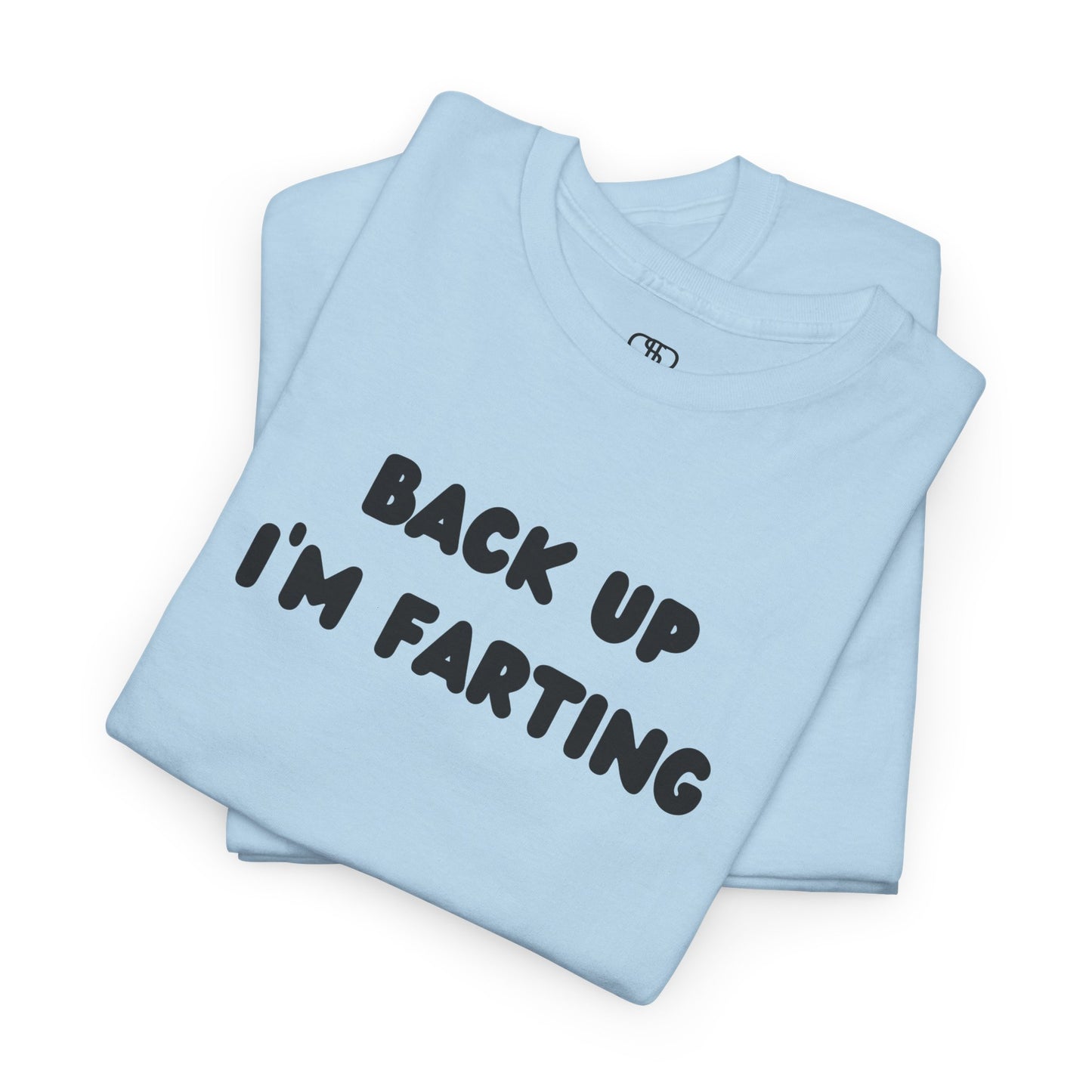 A folded light blue T-shirt with the bold text "Back Up I'm Farting" on the front.