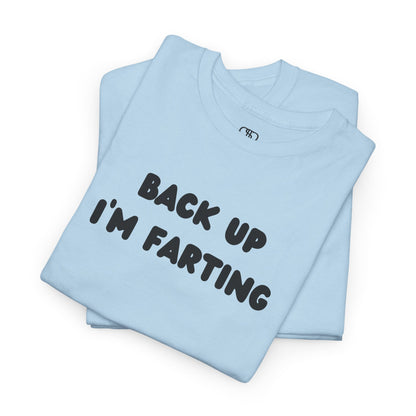A folded light blue T-shirt with the bold text "Back Up I'm Farting" on the front.