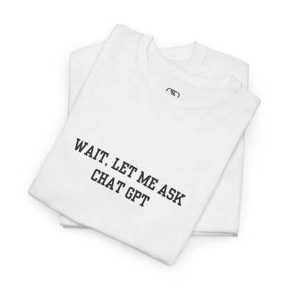A [folded white] t-shirt with the phrase “Wait, Let me ask Chat Gpt.” on the front.