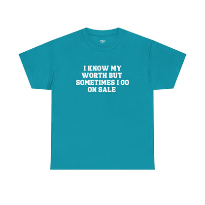 A [teal] t-shirt with the funny quote "I know my worth but sometimes I go on sale" printed in a clean, black font across the chest.