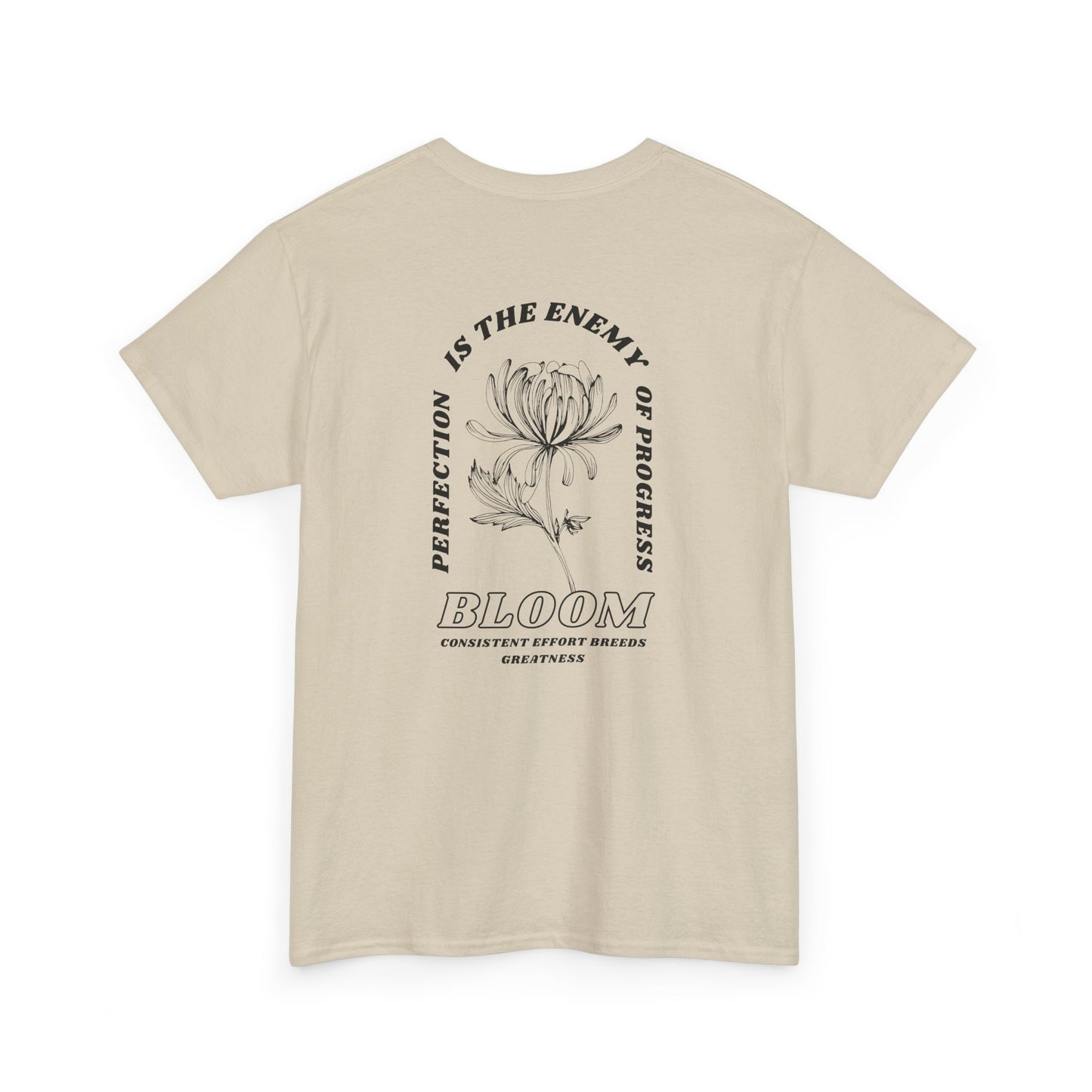 A [sand] t-shirt with a central flower design and the words “Perfection is the enemy of progress” and “Bloom” underneath it the phrase "Consistent effort breeds greatness," featured on the back of the t-shirt.
