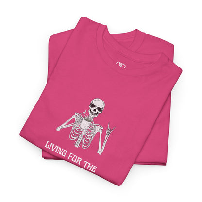A folded Pink T-shirt with a skeleton holding a hot coffee, displaying a rock hand symbol, and "Living For The Coffee" text.