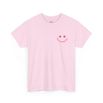 A light pink t-shirt with a retro smiley face on the front and the phrase “In my lifting Era” in a creative retro design on the back.