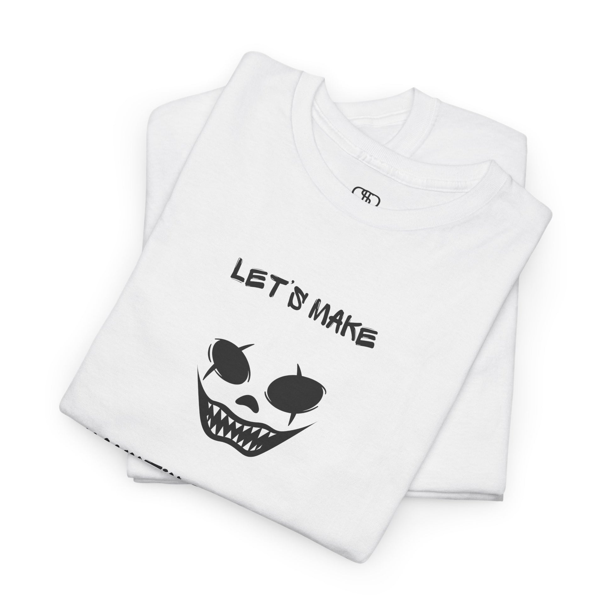 A folded white T-shirt with a daring clown graphic with sharp teeth and scars, and "Let’s Make Haunting Memories" text.