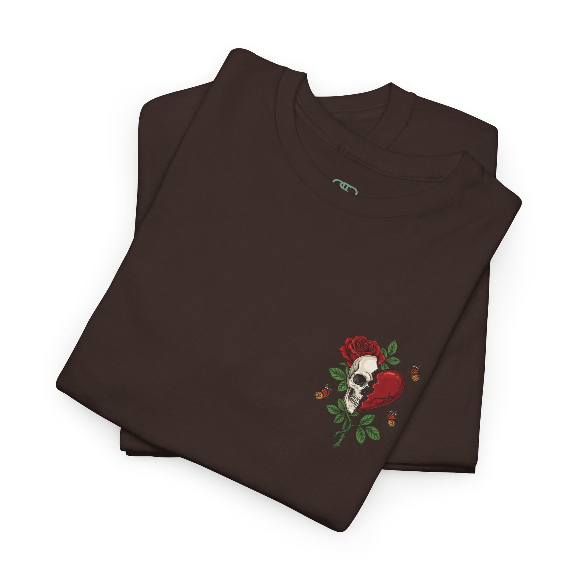 A folded dark brown t-shirt with a front design of a half skull, half broken heart, and a rose. The back reads "Gym Heals" in red.
