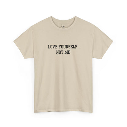 A minimalist sand t-shirt with the bold, centered text "Love yourself, not me" in a clean, modern font.