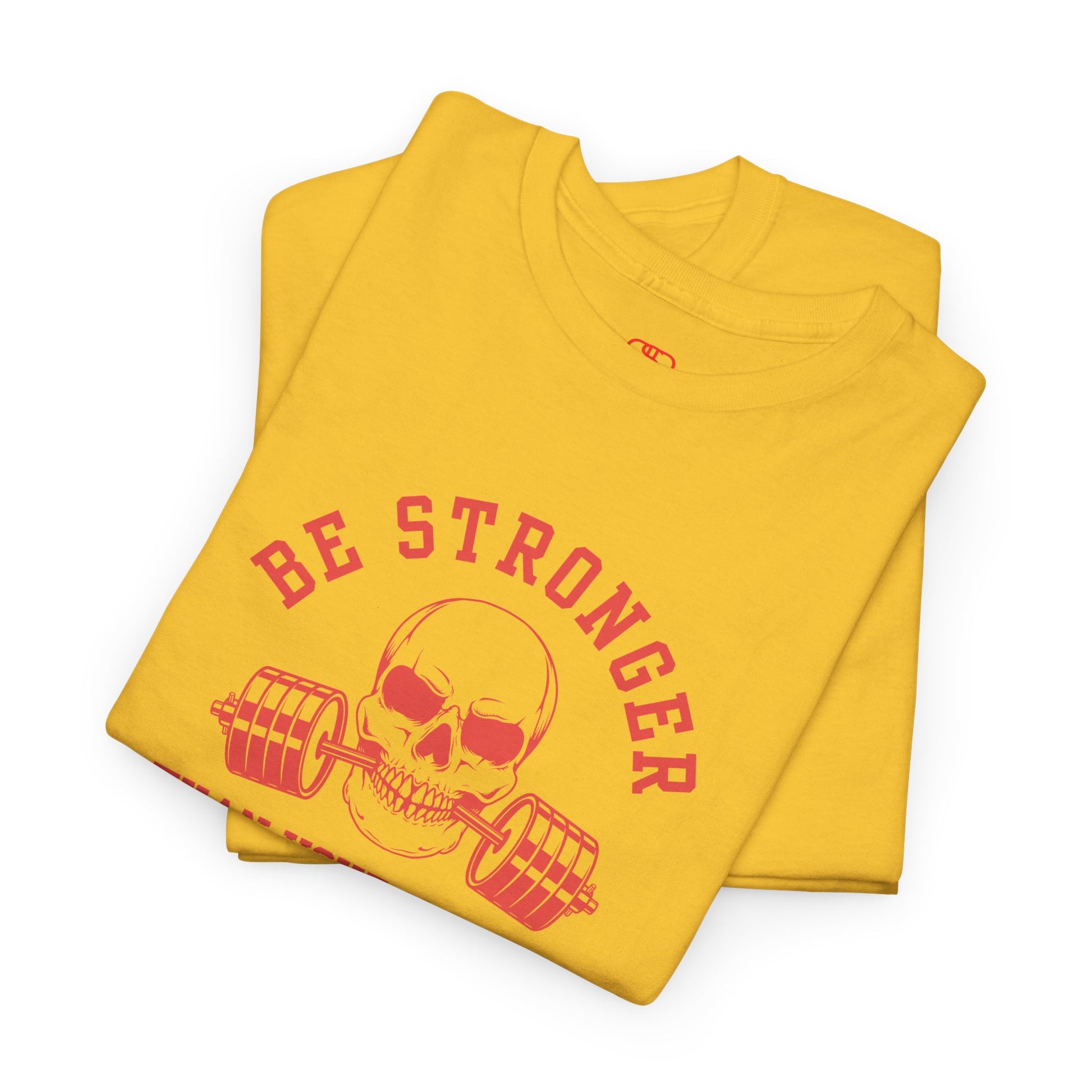 A t-shirt in [folded daisy] with a skull biting a barbell and the words “Be Stronger Than Your Excuses.”