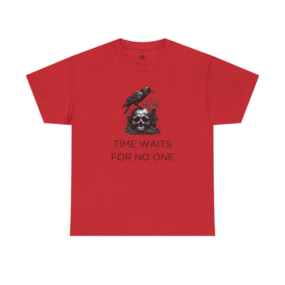 A close-up of a t-shirt with a gothic illustration. A black crow stands atop a weathered skull, which has moss and delicate vines growing through its eye sockets and around its form, blending nature and death.