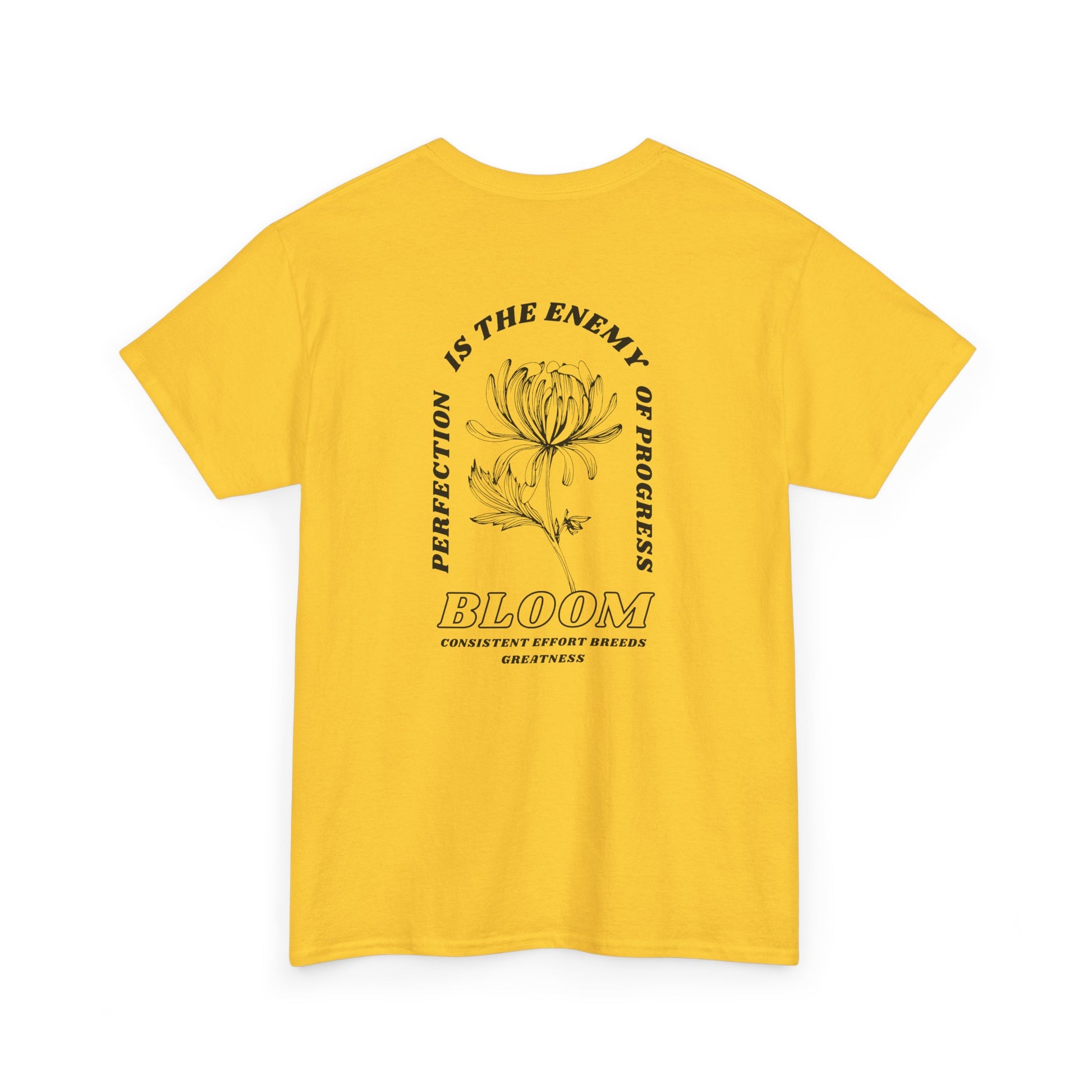 A [daisy] t-shirt with a central flower design and the words “Perfection is the enemy of progress” and “Bloom” underneath it the phrase "Consistent effort breeds greatness," featured on the back of the t-shirt.