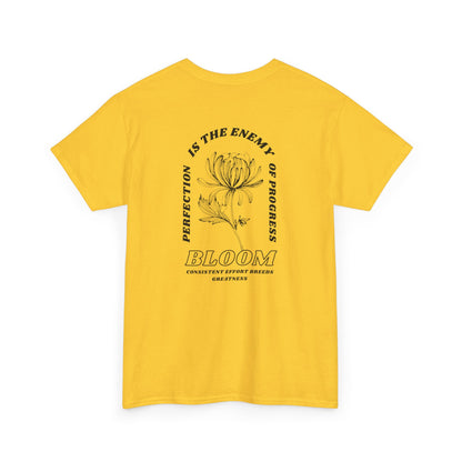A [daisy] t-shirt with a central flower design and the words “Perfection is the enemy of progress” and “Bloom” underneath it the phrase "Consistent effort breeds greatness," featured on the back of the t-shirt.