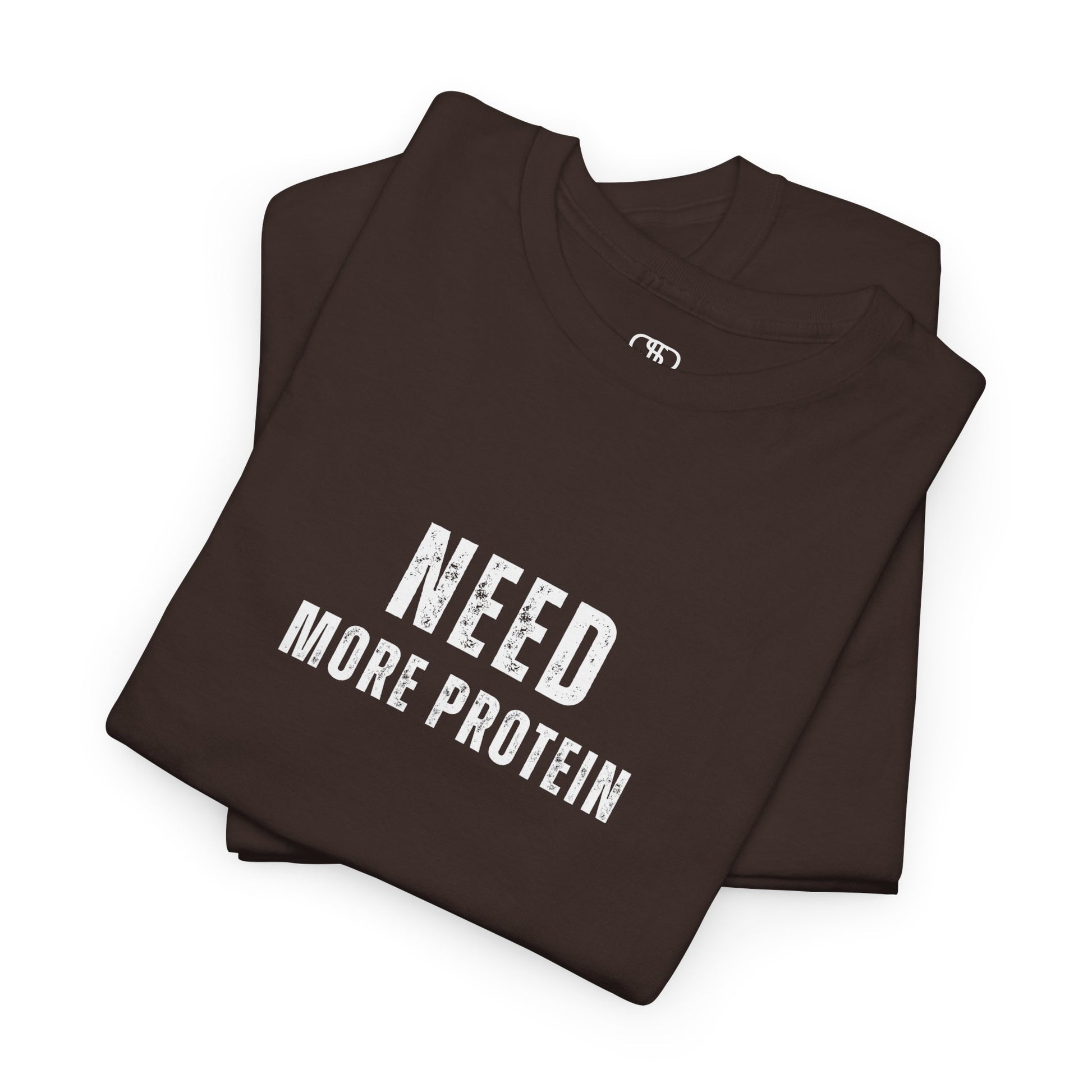 A folded dark brown t-shirt with the words “Need Protein” in a large grunge font.