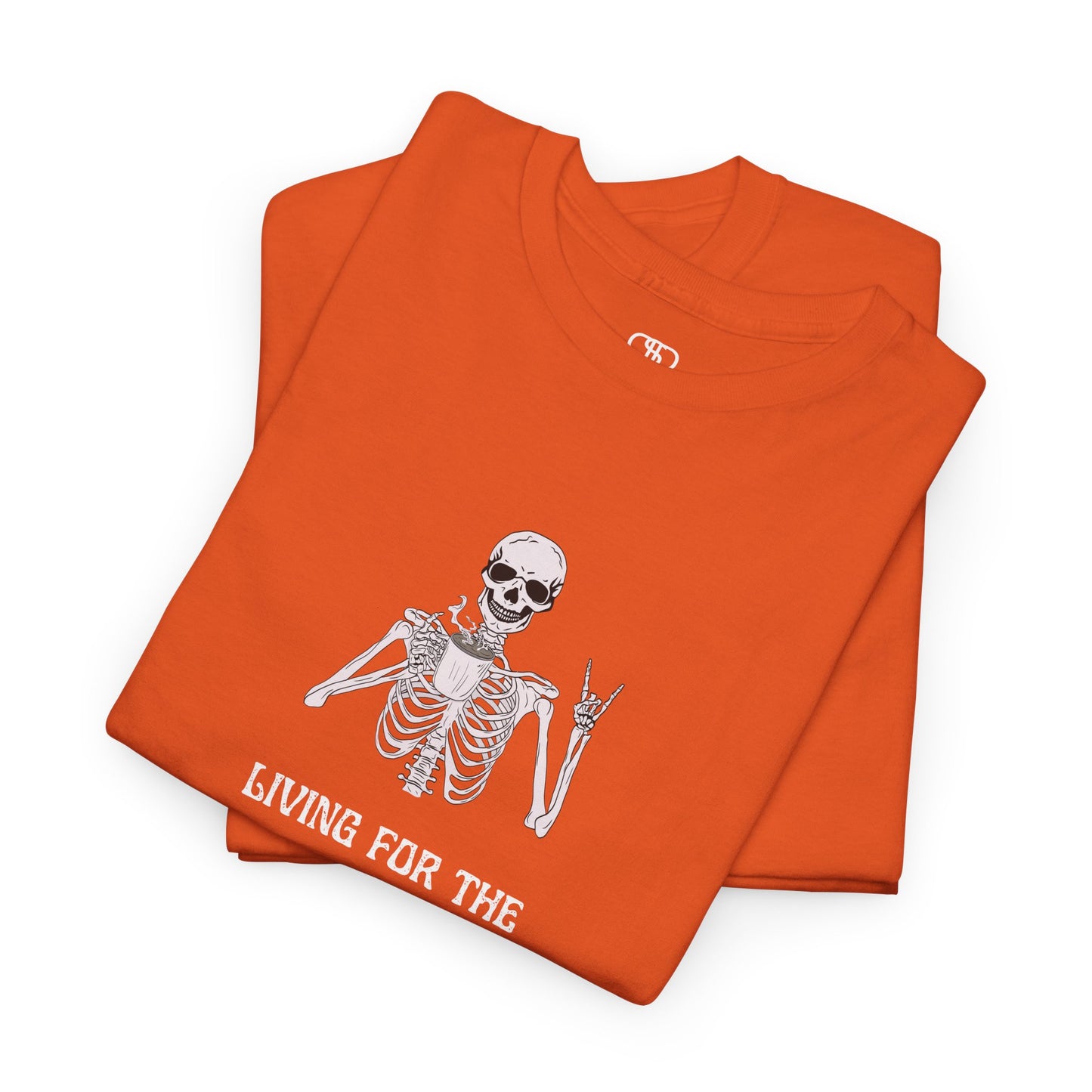 A folded orange T-shirt with a skeleton holding a hot coffee, displaying a rock hand symbol, and "Living For The Coffee" text.