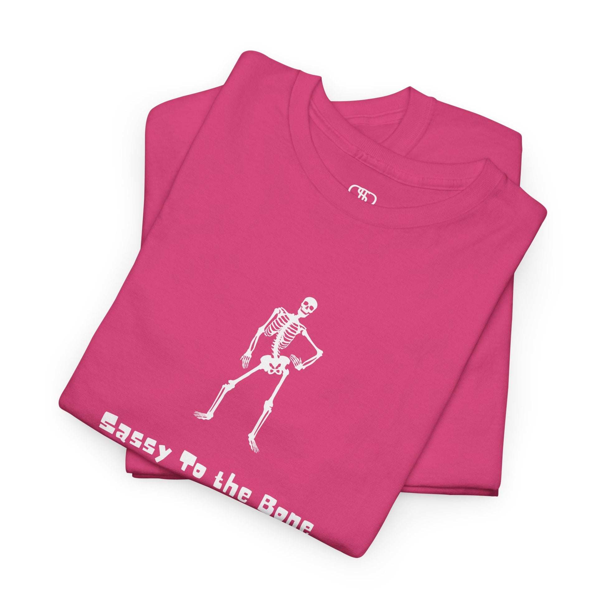 Folded Pink T-shirt with a sassy skeleton graphic with hands on hips and "Sassy to the Bone" text in a cartoon font.