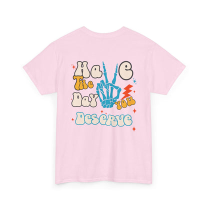 A [light pink] t-shirt with a skeletal peace sign on the front and the phrase “Have the day you deserve” with a large skeletal peace sign on the back.