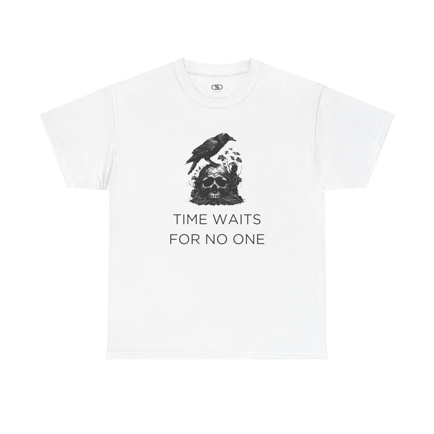 A close-up of a t-shirt with a gothic illustration. A black crow stands atop a weathered skull, which has moss and delicate vines growing through its eye sockets and around its form, blending nature and death.