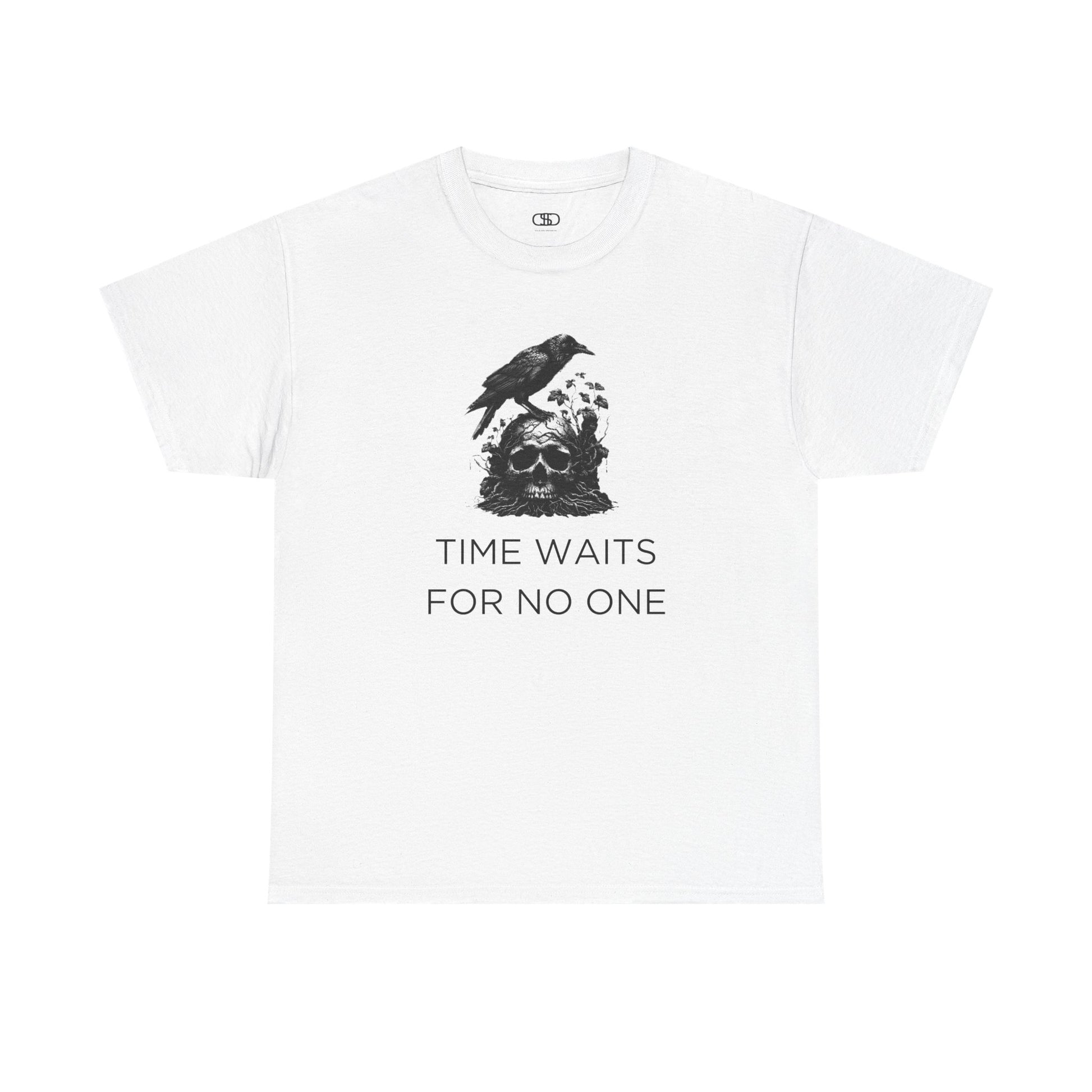 A close-up of a t-shirt with a gothic illustration. A black crow stands atop a weathered skull, which has moss and delicate vines growing through its eye sockets and around its form, blending nature and death.