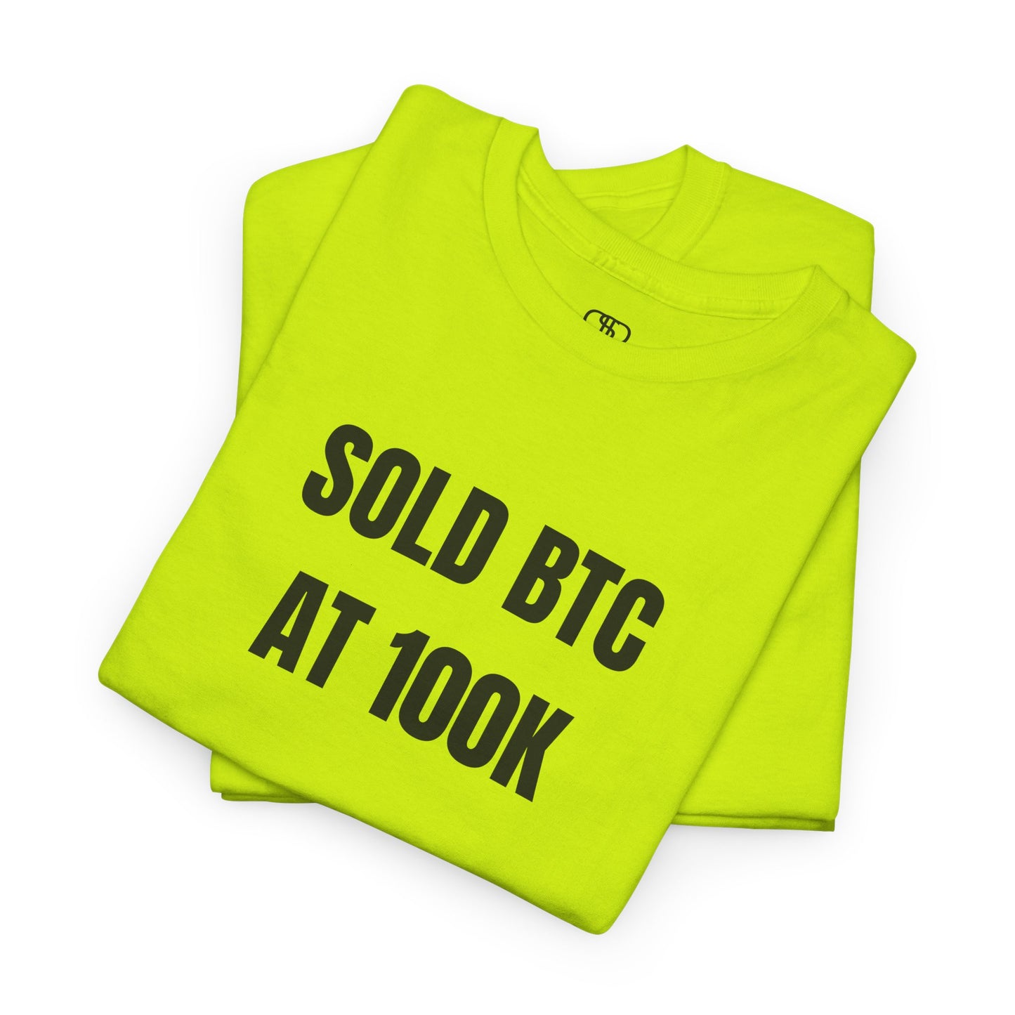 A folded safety green T-shirt with bold text "SOLD BTC At 100K" on the front.