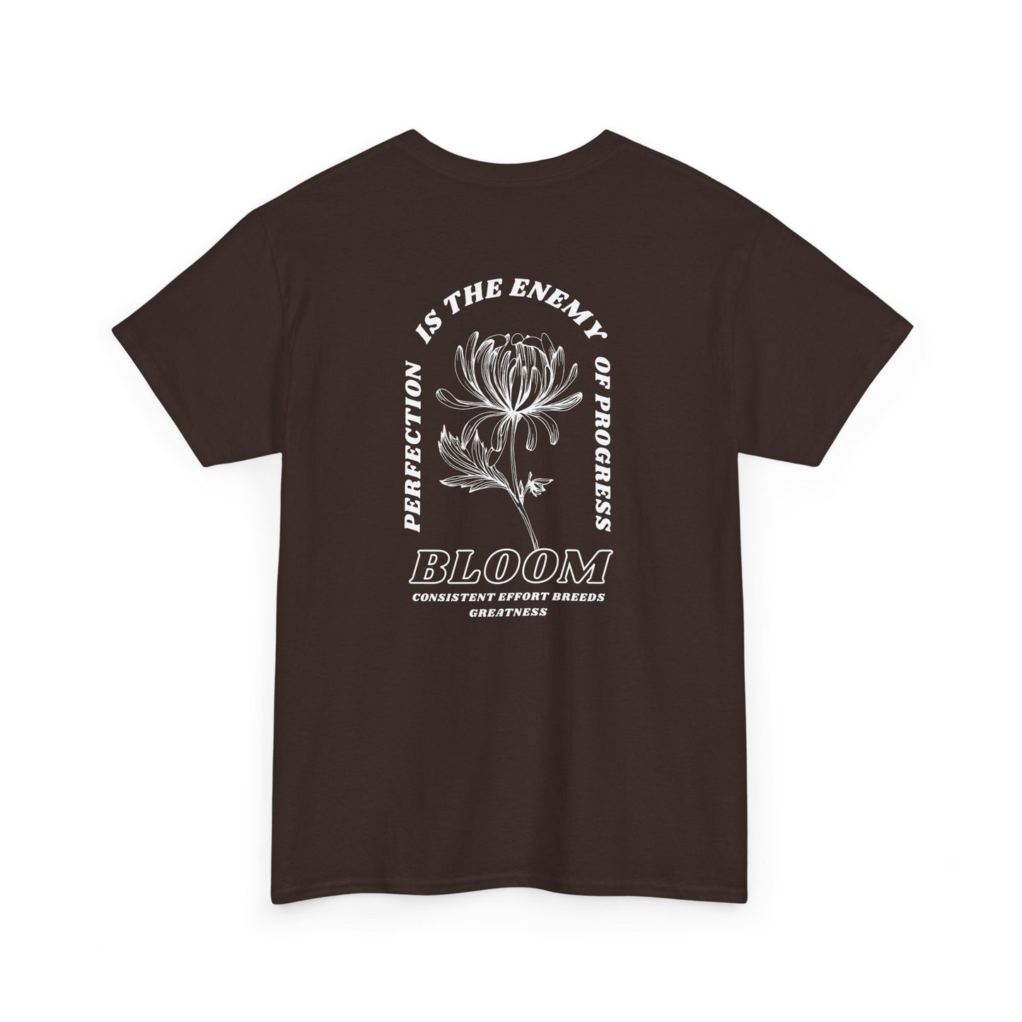 A [dark brown] t-shirt with a central flower design and the words “Perfection is the enemy of progress” and “Bloom” underneath it the phrase "Consistent effort breeds greatness," featured on the back of the t-shirt.