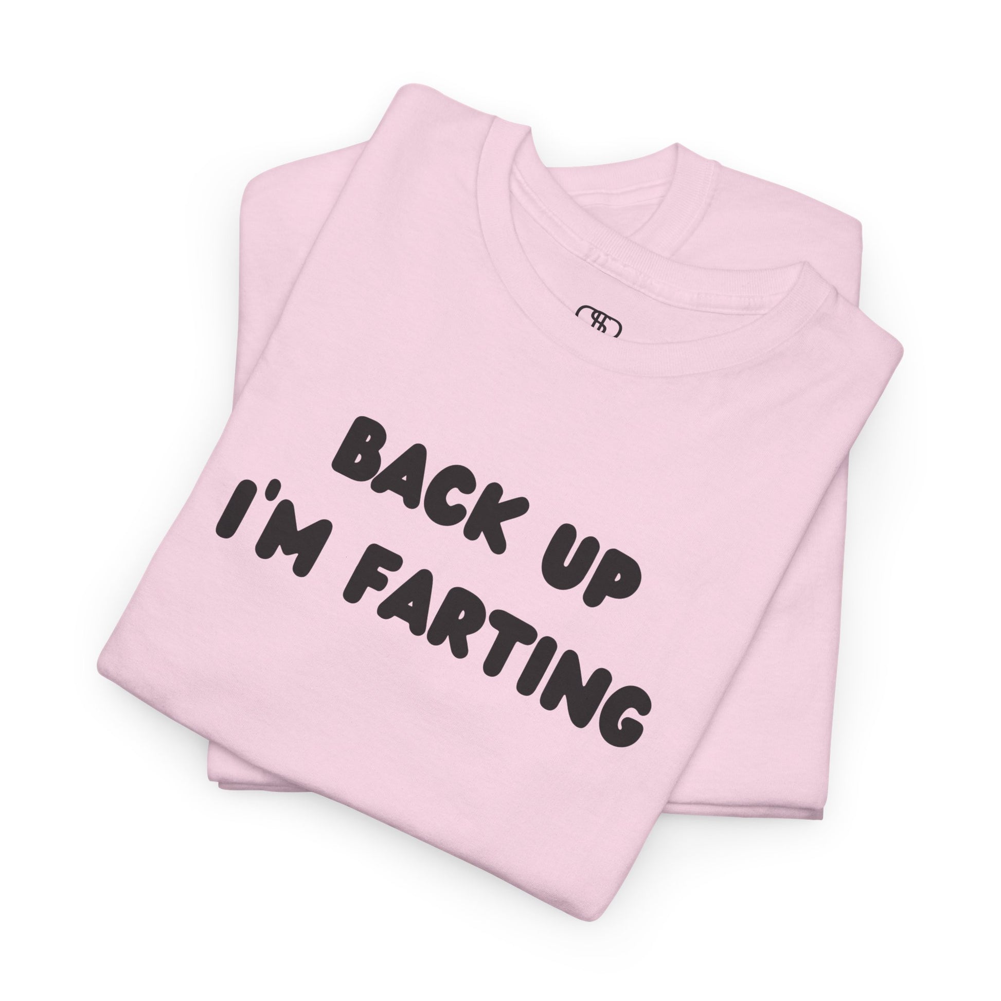 A folded light pink T-shirt with the bold text "Back Up I'm Farting" on the front.
