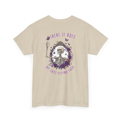 A sand t-shirt with a skeleton hand flipping its middle finger on the front surrounded by vines, roses, & butterflies, and a full skeleton design on the back with the phrase “My Last Flying Fuck.”