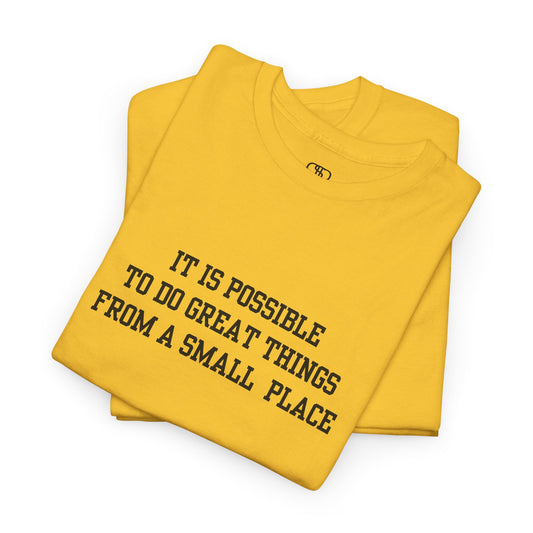 A daisy t-shirt with the quote “It is possible to do great things from a small place” on the front.