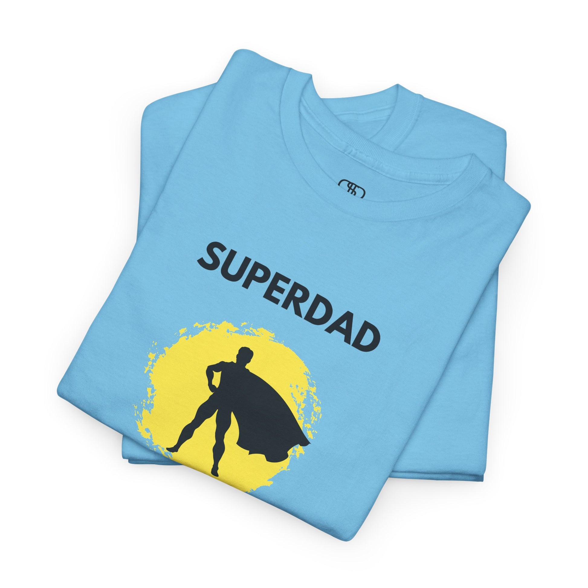  A folded sky blue T-shirt with a "Superdad" text and a silhouette of a person with a cape on a yellow circle background.